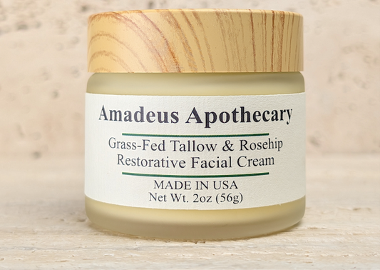 Amadeus Apothecary facial cream jar with a wood-patterned lid on a light stone surface.